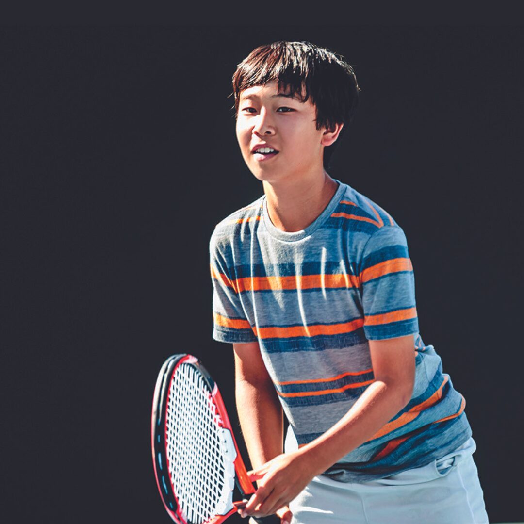 Kid playing tennis at tennis camp
